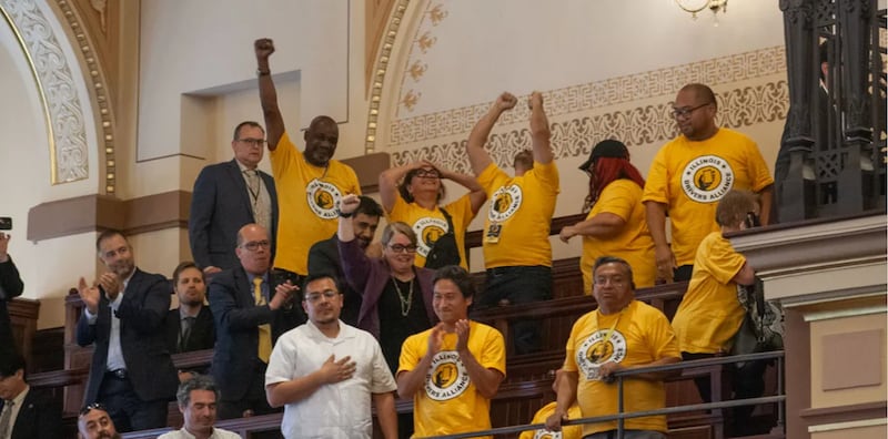 Supporters of the rideshare union bill celebrate in the Senate gallery after the bill passed on the floor.