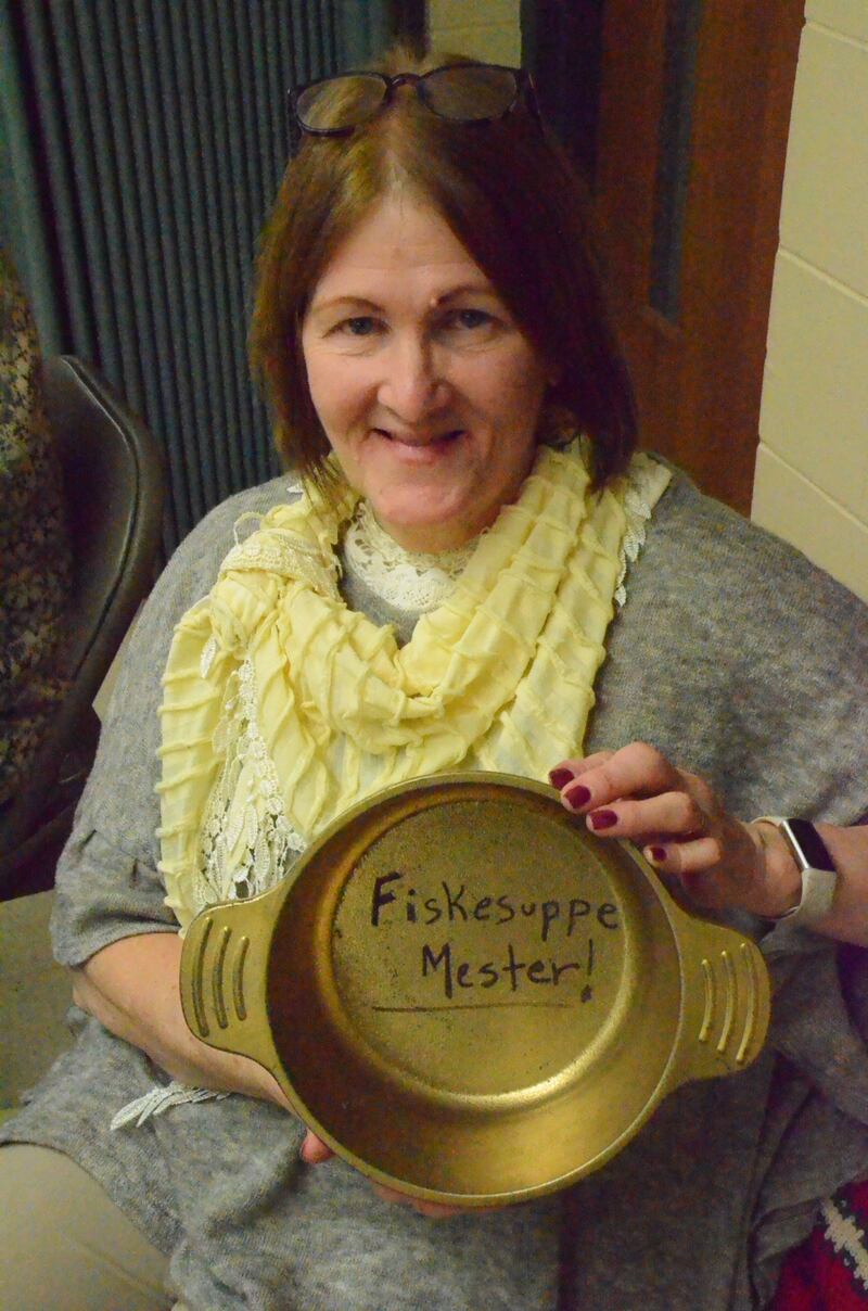 Yorkville resident Jeanne Leifheit displays an inscribed gold-colored soup pot, a traveling trophy she won in an annual Norwegian soup contest held at St. Olaf Lutheran Church in Montgomery on Sunday, Feb. 1, 2026.