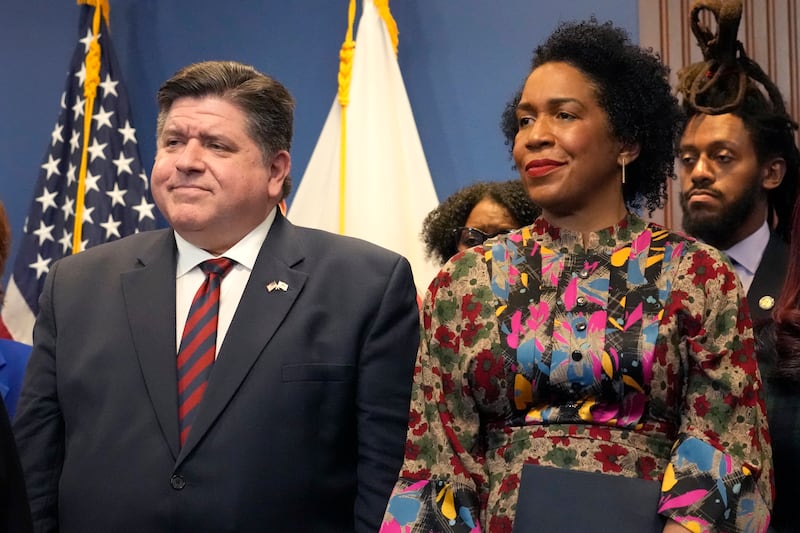 Illinois Gov. J.B. Pritzker listens to a speaker with Lt. Gov. Juliana Stratton during the Illinois Paid Leave bill signing ceremony Monday, March 13, 2023, in Chicago. (AP Photo/Charles Rex Arbogast)