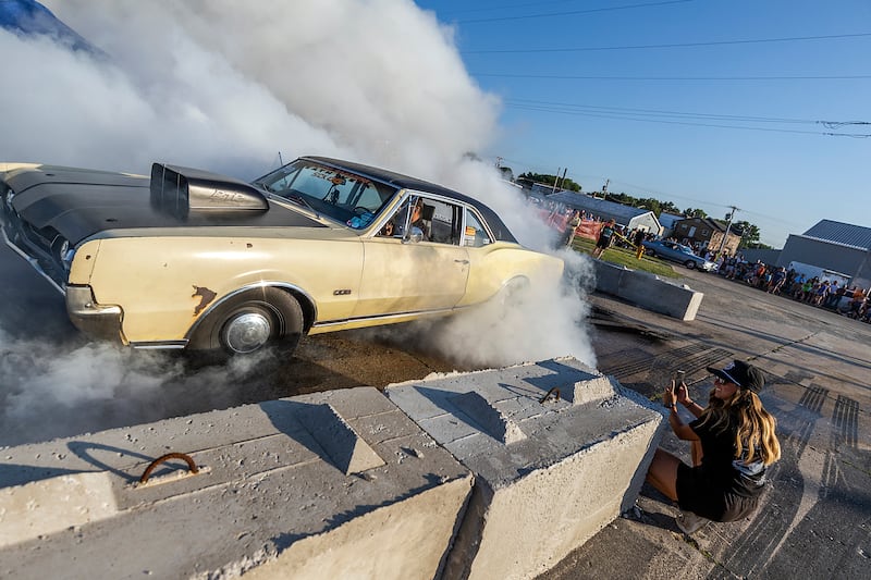 Lexi Upson gets close up video as Rajveer Ahuja smokes the tires Thursday, June 19, 2025, during the burnout show in Rock Falls.