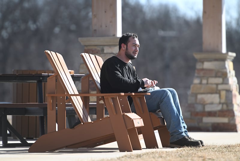 Carpentersville resident Austin Eisenhauer enjoys Monday’s nice weather with lunch and a lake view at Rotary Park on Klasen Road in Cary. Eisenhauer, who was on break from his Crystal Lake job, also took a walk on the park’s trails after eating.