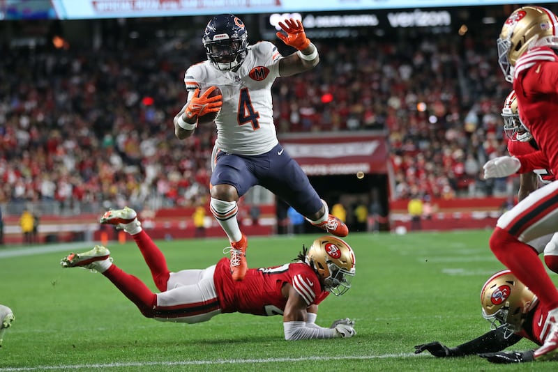 Chicago Bears' D'Andre Swift leaps over San Francisco 49ers' Ji'Ayir Brown to score a 3rd quarter touchdown during Niners' 42-38 win in NFL game at Levi's Stadium in Santa Clara, Calif., on Sunday, Dec. 28, 2025. (Scott Strazzante/San Francisco Chronicle via AP)