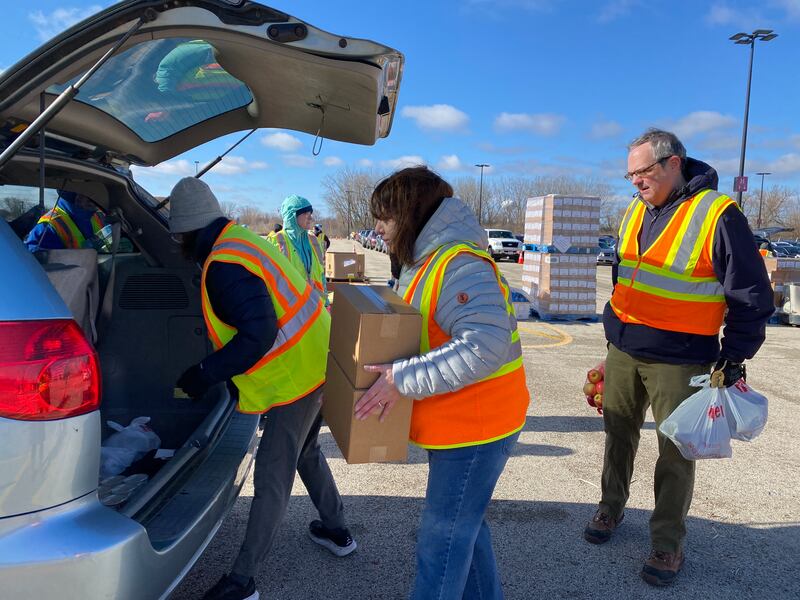 Volunteers oack boxes to be distributed to area food pantries from Northern Illinois Food Bank. The bank expects to service thousands this holiday season, noting the need to address food insecurity is higher than numbers recorded during the COVID-19 pandemic.