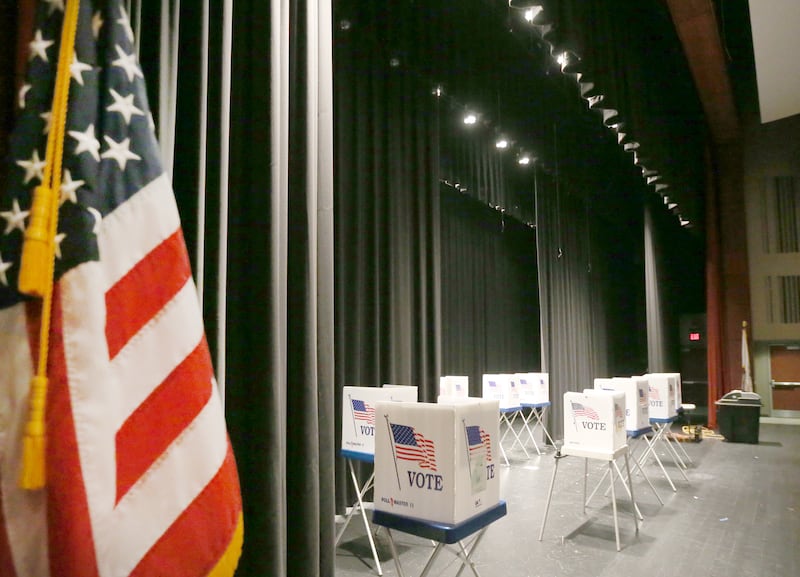 Empty voting booths fill the stage of a polling place on Tuesday, March 19, 2024 at Hall High School in Spring Valley.