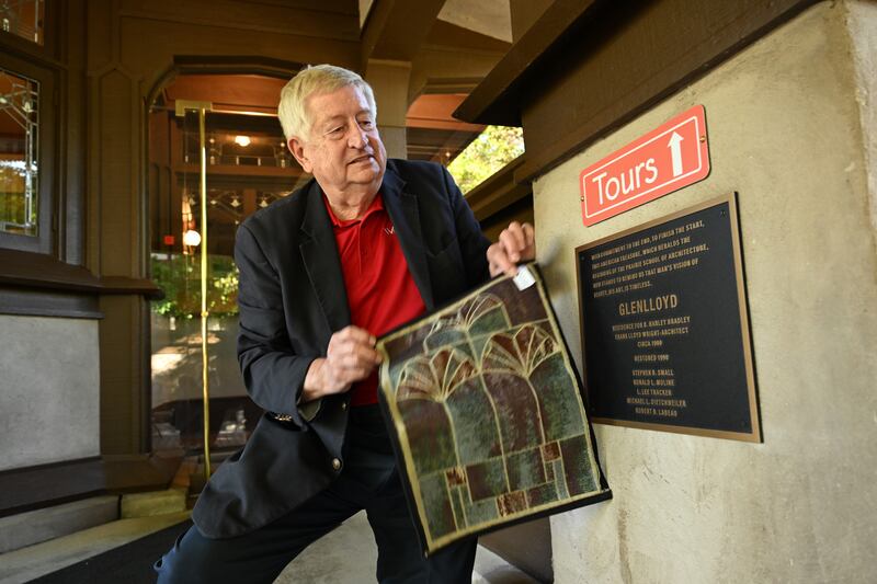 Bob Bohlmann, Executive Director of Wright in Kankakee, reveals the newly rededicated plaque honoring GLENLLOYD, former owner of the B. Harley Bradley House, on Sunday, Oct. 12, 2025.
