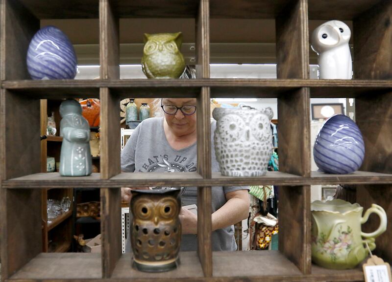 Nance Lopotko of the Eclectic Avenue booth in Q'Tiques in McHenry works Tuesday, March 4, 2025, on preparing for this weekend's Shop Hop. More than 300 vintage and antique shops are participating in Wisconsin and Illinois.