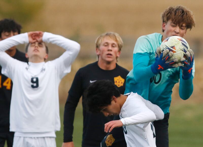 Richmond-Burton's Easton Wold grabs the ball over F.W. Parker's Rohan Liew as F.W. Parker's Johnny Backx reacts to a missed scoring opportunity during an IHSA Class 1A Johnsburg Sectional semifinal match on Oct. 28, 2025, at Johnsburg High School.