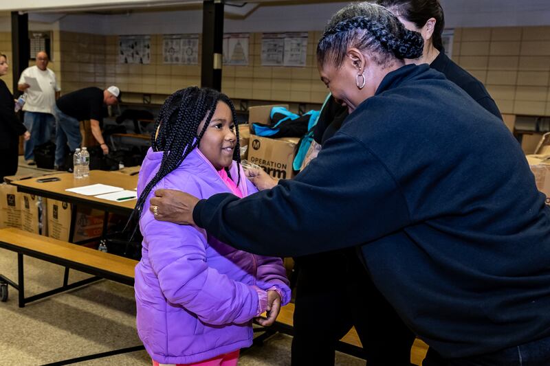 Nicor Community Affairs Manager Pat Eaves helps second grader Bria Smith find the perfect fit during the winter coat event hosted by Nicor Gas, in collaboration with Operation Warm, at T. E. Culbertson Elementary School on Nov. 7, 2025.