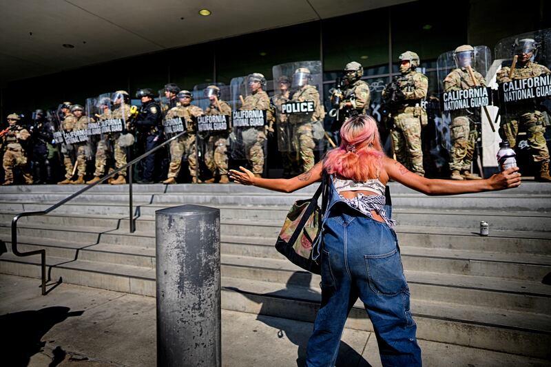 A protester taunts a line of California National Guard protecting a federal building in downtown Los Angeles on Monday, June 9, 2025. (AP Photo/Eric Thayer)