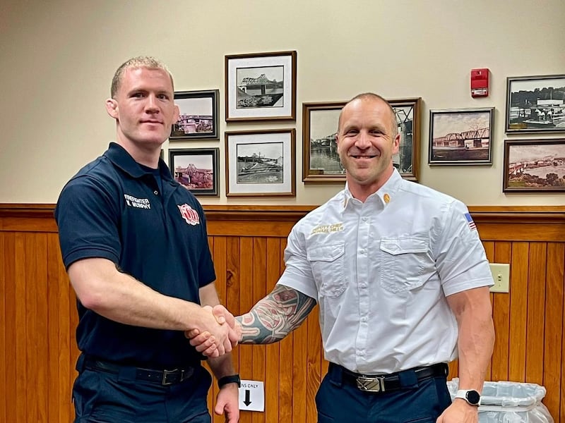Matt Murphy, left, poses for a photo with Deputy Fire Chief Michael Mills during his swearing-in ceremony this week at Ottawa City Hall.