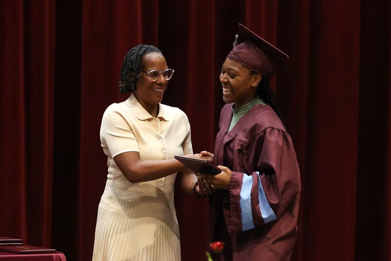 Kankakee High School graduate Tia Dean smiles as she accepts her diploma from Kankakee School District 111 Superintendent Teresa Lance, left, during the summer commencement ceremony at the high school on Tuesday, July 29, 2025.