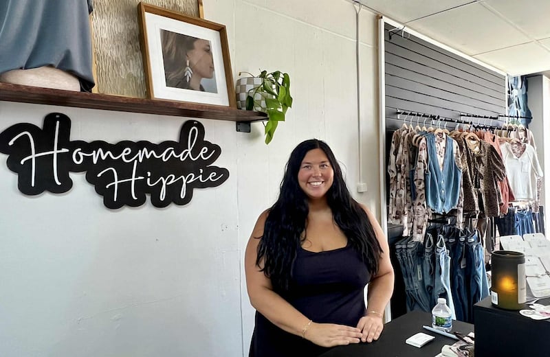Chelsea Lesniewski stands ready to greet customers behind the desk of her shop, Homemade Hippie Boutique in Fulton.