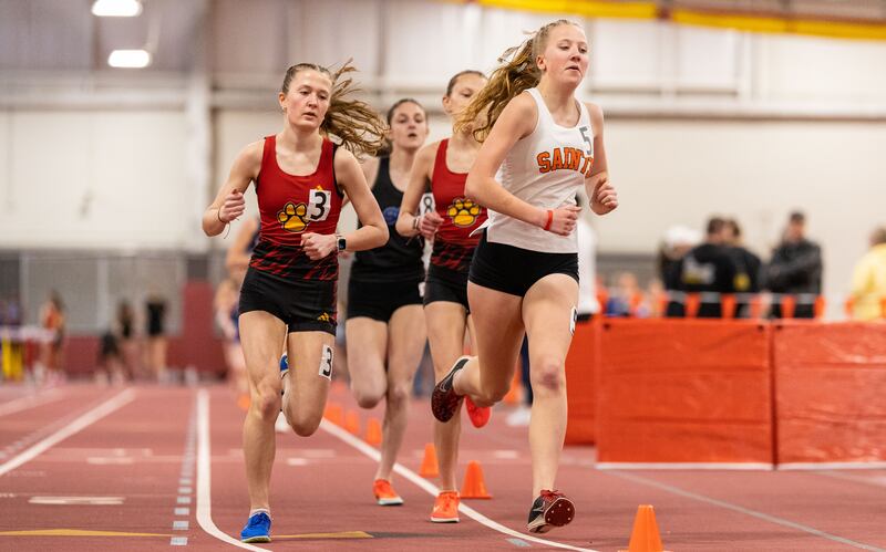 Adley Wilson, front, participates in the 3200 meter run during the Girls Track and Field DuKane Conference Meet at Batavia High School on Saturday, March 22, 2025.