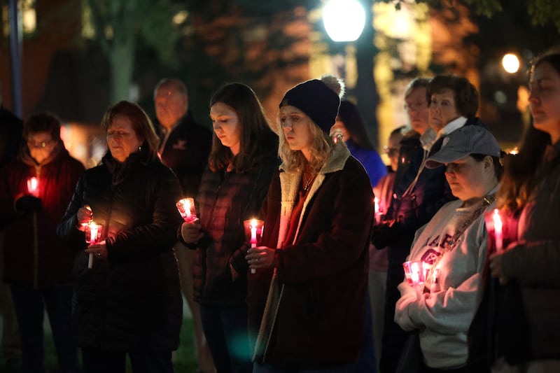 Tiffany DeRocco, of St. Anne, pauses in a moment of silence for the four local victims that died of domestic violence in the past year alongside fellow attendees during the 7th annual Harbor House Candlelight Vigil on Thursday, Oct. 23, 2025, at the Kankakee County Courthouse.
