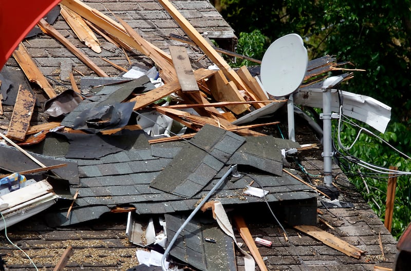 Debris on the neighbors home as authorities look for the cause of a home explosion on Monday, May 18, 2026, in 7400 block of Birch Drive, in Wonder Lake, after the Sunday evening explosion. One resident of a home was killed and two others have been taken to the hospital.
