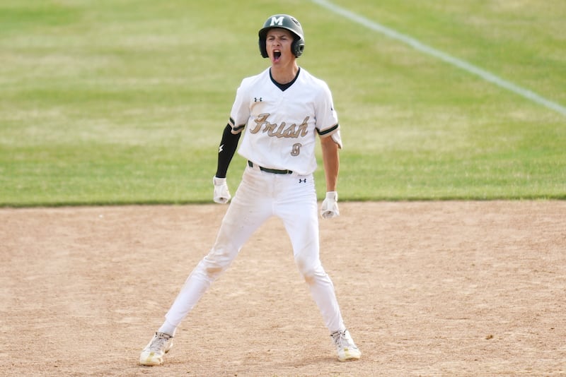Bishop McNamara's Nick Pignatiello yells to the Fightin' Irish dugout after his go-ahead two-run single in the Class 2A Bishop McNamara Regional semifinal against Herscher Thursday, May 28, 2026.