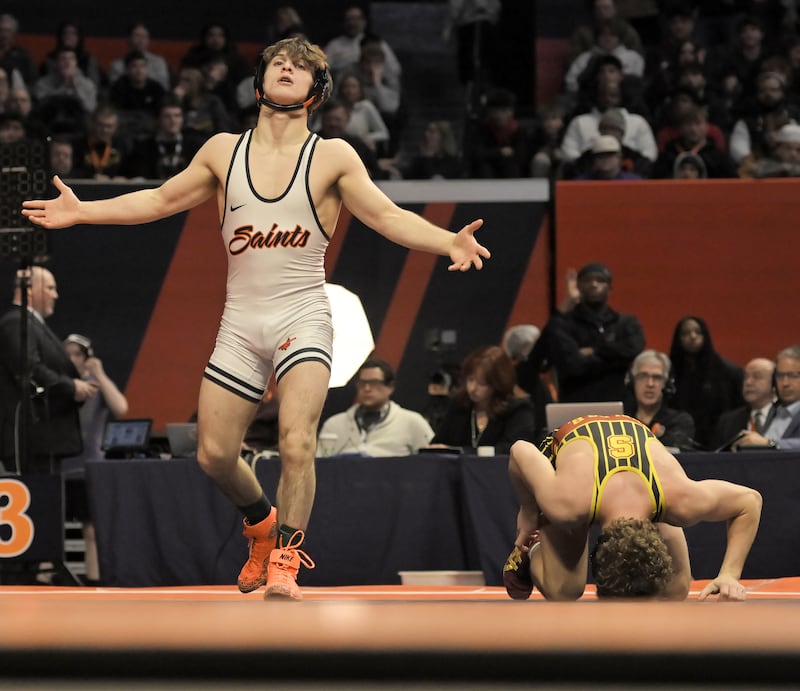St. Charles East’s Dom Munaretto reacts after defeating Schaumburg’s Brady Phelps in the Class 3A 120-pound final at the IHSA boys state wrestling championships at the State Farm Center in Champaign on Saturday, Feb. 22, 2025.