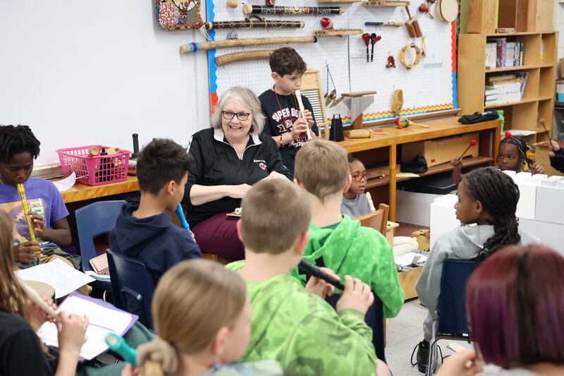 Pat Gordon, music teacher at Momence's JeNeir Elementary School, smiles as her students rehearse songs on recorders and percussion during class on April 17.