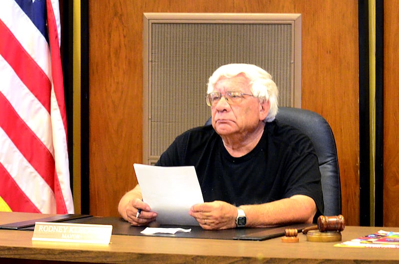 Rock Falls Mayor Rod Kleckler listens to Police Chief Dave Pilgrim as he announces his retirement from the force.