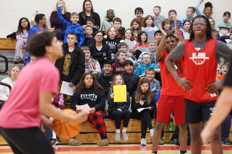 St. Anne Grade School students cheer for St. Anne High School basketball players during the district's Math Madness held on March 20 at the high school.