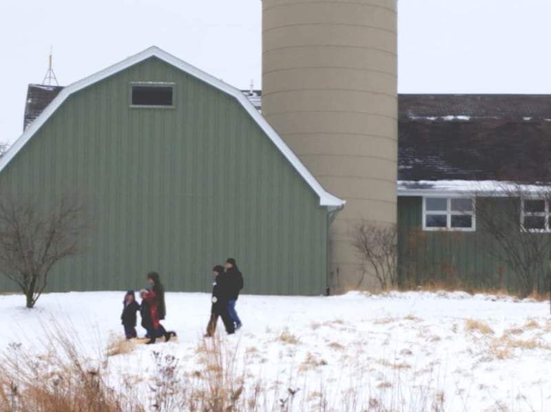 People walk in the snow at WinterFest 2020 at the Volo Bog State Natural Area in Ingleside.