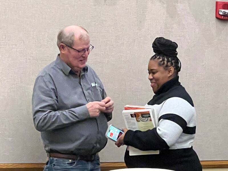 New County Board member Savannah Ilenikhena, a Republican from District 5, talks with board member John Frieders, a Republican from District 12, after an hour long presentation from County Administrator, Brian Gregory on Dec. 14, 2022.