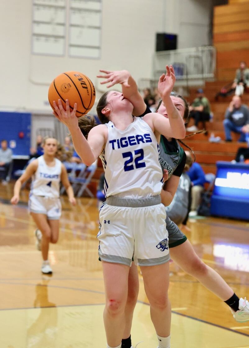Princeton's Camryn Driscoll gets a helping hand against Midland Thursday night at Prouty Gym. The Tigresses won 69-34 to improve to 3-0 and advance to Saturday's championship game.