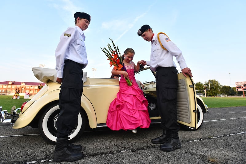 Zoey Kleinert, a 2021 Gladiolus Festival princess candidate, is assisted by members of the Momence Honor Guard on during the coronation program at Momence High School.