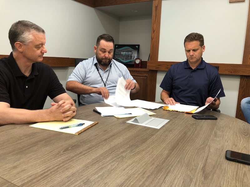 McHenry School District 15 Board President Chad Mihevc, left, Chief Financial Officer Jeff Schubert and Superintendent Josh Reitz opened two bids for Landmark School on Monday, July 28, 2025. The School Board is expected to vote on the bids at an August meeting.