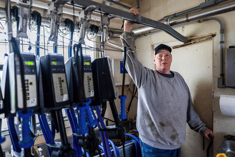 In this photo released by The Wisconsin Institute for Law and Liberty, Faust’s attorneys, Wisconsin dairy farmer Adam Faust, who is suing the Trump administration alleging discrimination against white farmers like him, poses inside his dairy barn in Chilton, Wisconsin, in 2021. (The Wisconsin Institute for Law and Liberty via AP)