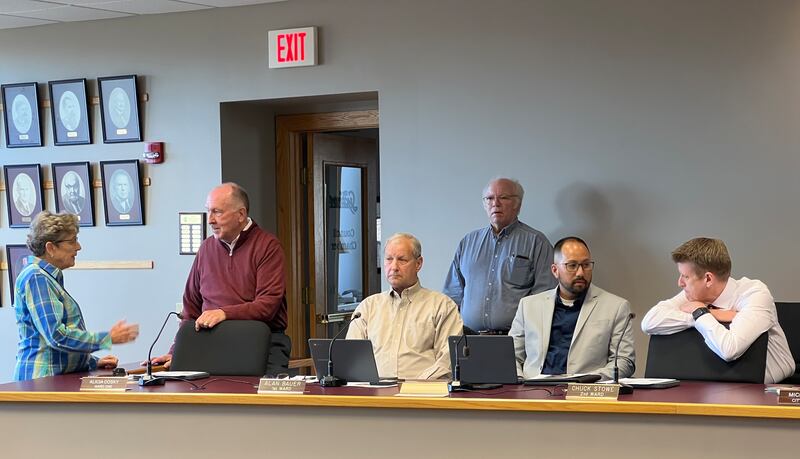 First Ward Alderperson Alicia Cosky talks with 3rd Ward Alderperson Marvin Barnes, while 1st Ward Alderperson Alan Bauer and 2nd Ward Alderperson Chuck Stowe look on ahead of a Sycamore City Council meeting on May 20, 2025. On the right, Michael Rodriguez talks with Sycamore City Manager Michael Hall before he was appointed to fill a vacant 2nd Ward Alderperson position.