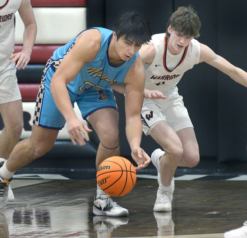 Marquette’s Michael Coutts and Woodland’s Nate Berry chase down a loose ball in the 1st period Friday at Woodland.
