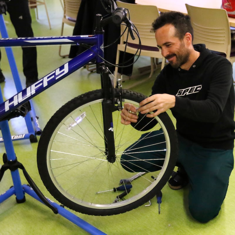 Josh Davis, of Spec, trues a wheel of a bicycle during a Repair Fair on Tuesday, April 15, 2025, at McHenry County College.