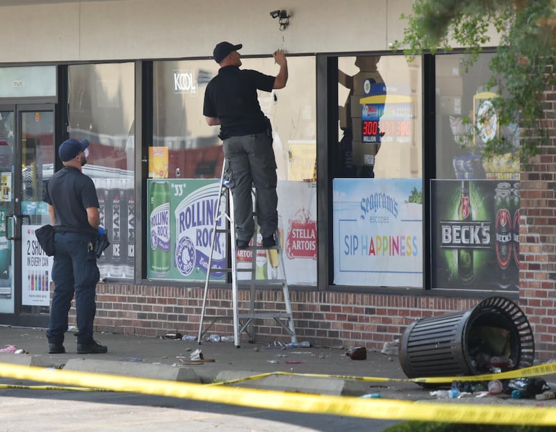 Police investigators mark an apparent bullet hole on the front of Five Star Pantry at 10S620 Kingery Hwy. in Willowbrook on Monday, June 20. 2023. There was  a mass shooting there early Sunday morning as a unsanctioned party took place in the parking lot.