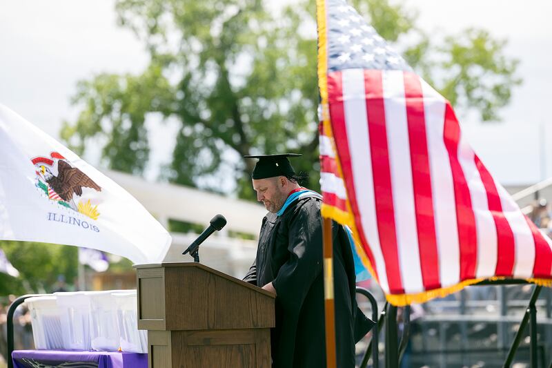 Dixon principal Jared Shaner tells the graduates to “Be Where Your Feet Are,” Sunday, May 25, 2025, during Dixon High School’s graduation. Shaner reminded the audience to slow down and be in the moment.