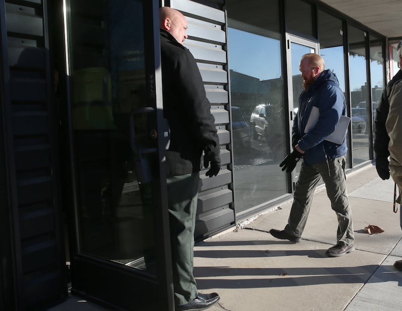 Nick Fox, CL Enterprises Vice President of Construction and Development holds the door open for Scott Brown, structural department manager at Willett, Hofmann & Associates at the entrance of the former Maytag building on the corner of First Street and Joliet Streets on Wednesday, Jan. 8, 2025 downtown La Salle. CL Enterprises and La Salle City officials met together for an inspection of the Maytag and Kaskaskia buildings.