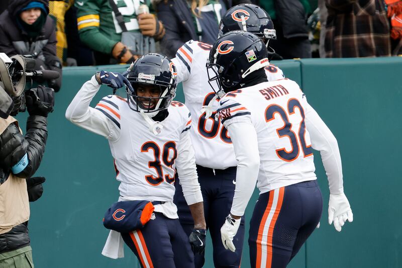 Chicago Bears' Josh Blackwell (39) celebrates after scoring on a punt return with Terell Smith (32) and Collin Johnson during the first half of an NFL football game against the Green Bay Packers, Sunday, Jan. 5, 2025, in Green Bay, Wis. (AP Photo/Mike Roemer)