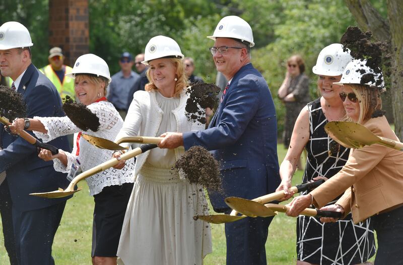 DuPage County board members, including Brian Krajewski, middle, throw shovels of dirt at a ground breaking ceremony for an expansion of the animal service shelter on county Farm Road in Wheaton on Tuesday, July 18, 2023. Krajewski is the committee chairman for the project.