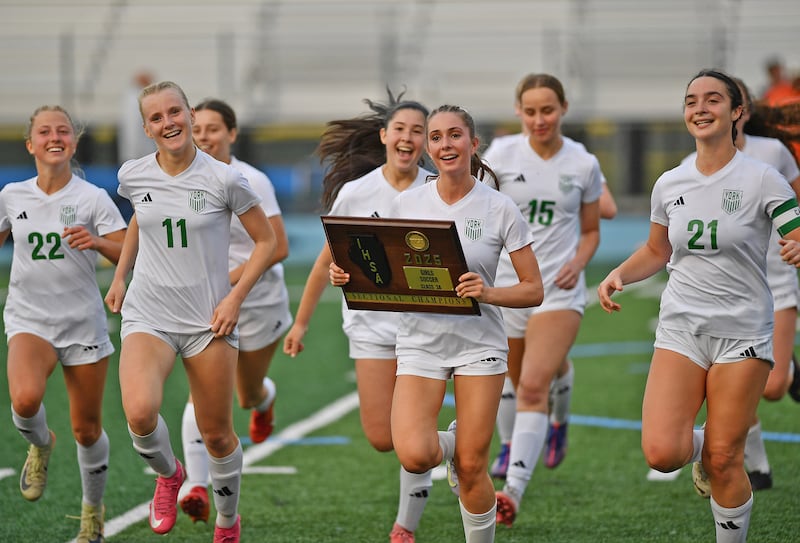 Carrying the Sectional championship plaque is York’s Maggie Quinn, who scored the only goal of the game against Hinsdale Central the Class 3A Downers Grove South Sectional final game on May 30, 2025 at Downers Grove South High School in Downers Grove .
