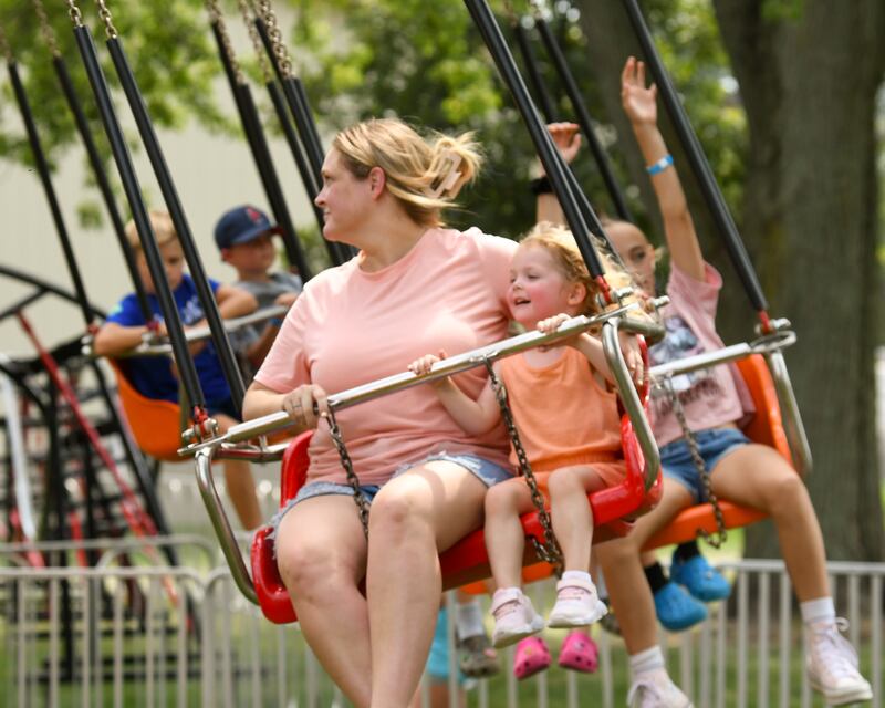Maeve Hendrickson 3, of Elburn is all smiles as she rides a carnival ride with her mom Megan Hendrickson on Saturday Aug 16, 2025, during Elburn Days held at Lions Park in Elburn.