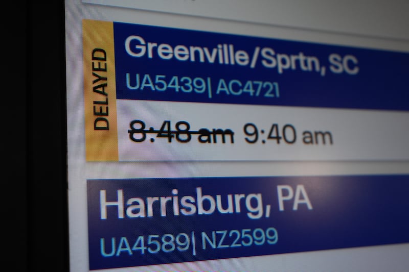 An information sign displays a delayed flight at O'Hare International Airport in Chicago, Friday, Nov. 7, 2025. (AP Photo/Nam Y. Huh)
