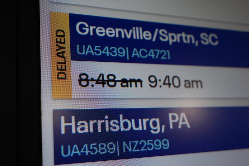 An information sign displays a delayed flight at O'Hare International Airport in Chicago, Friday, Nov. 7, 2025. (AP Photo/Nam Y. Huh)