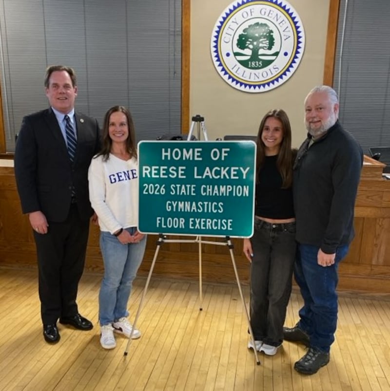 The city of Geneva unveiled a new sign for Geneva High School senior Reese Lackey, second from right, as the 2026 State Champion Gymnastics Floor Exercise. Mayor Kevin Burns, (left) mom Courtney and dad Darren, far right, stand with the sign at the April 6, 2026 city council meeting.