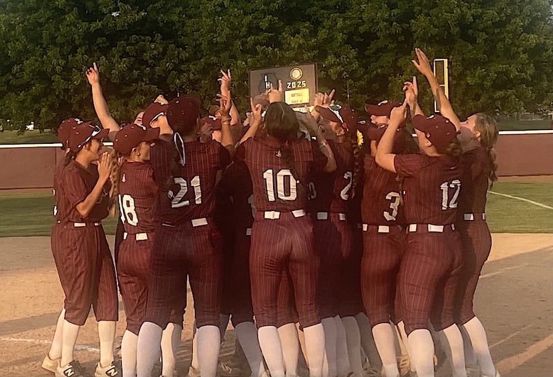 Lockport's softball team celebrates after beating Lincoln-Way Central 2-0 in 10 innings for the Class 4A Lockport Sectional title.