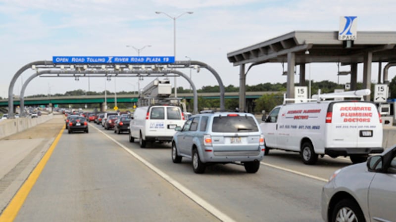 Drivers pass through the River Road Toll Plaza July 28 in Rosemont. On Thursday the Illinois Tollway Board of Directors approved a plan that will nearly double tolls to pay for a $12 billion capital plan.