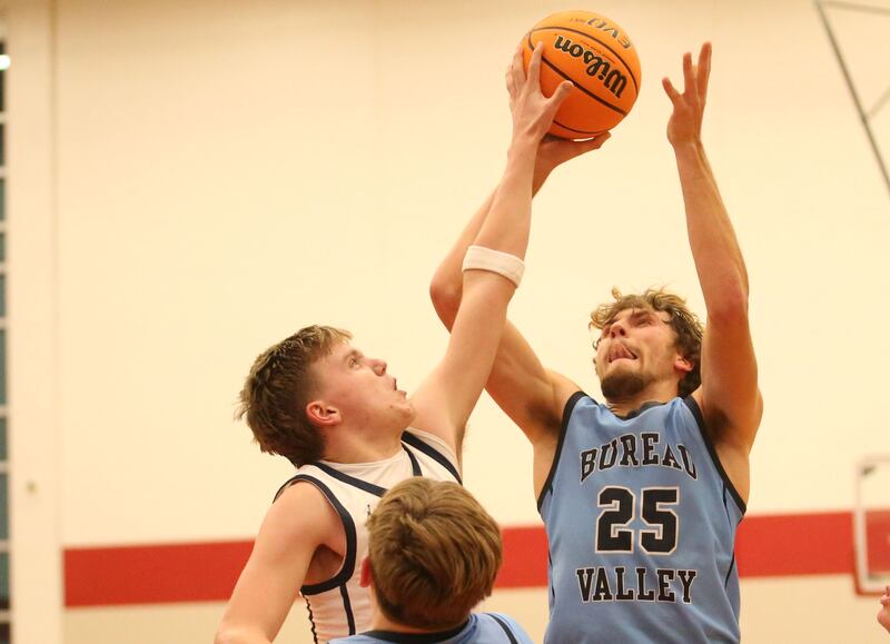 Fieldcrest's Layten Gerdes gets a piece of the ball on Bureau Valley's Landon Hulsing's shot during the 50th annual Colmone Classic on Monday, Dec. 9, 2024 at Hall High School.