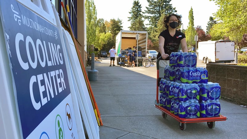 A volunteer helps set up snacks at a cooling center established to help vulnerable residents ride out the dangerous heat.