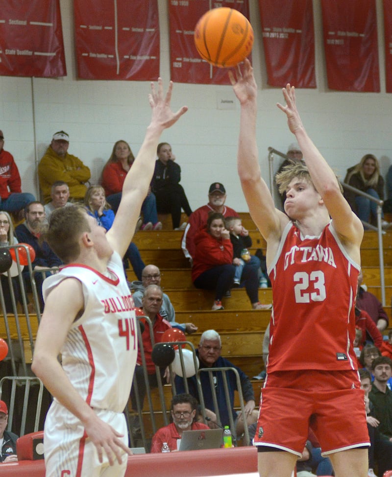 Ottawa’s Owen Sanders (23) shoots over the block attempt of Streator’s Nolan Lukach (44) in the third period Saturday at Streator.