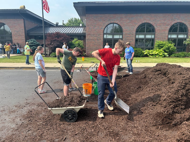 Macen Mulderink and Ian bush helped the with the Morrison Garden Club landscaping project at the Odell Public library on May 31.