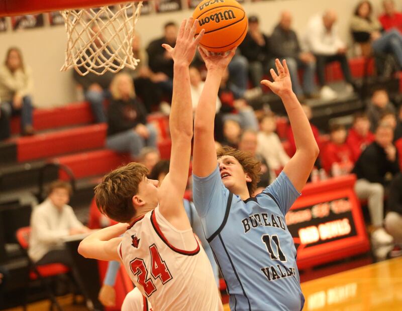 Bureau Valley's Blake Foster posts up a shot over Hall's Gage Olson on Wednesday, Jan. 28, 2026 at Hall High School.